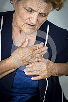 Senior woman having chest pain