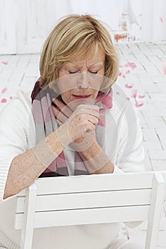 Senior woman having a cold photo