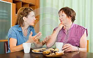 Senior woman having discussion with her daughter