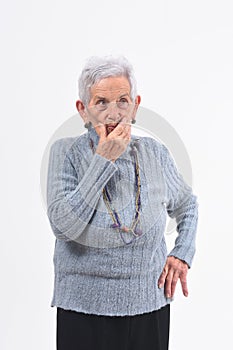 Senior woman having doubts and questions on white background