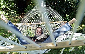 Senior woman having fun in hammock