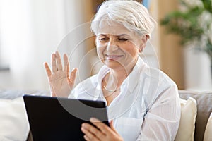 Senior woman having video chat on tablet pc