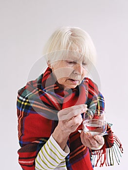 Senior woman with headache in plaid.