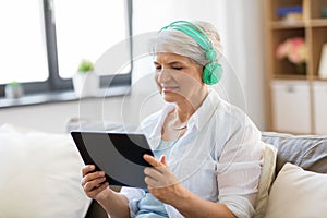 Senior woman in headphones listening to music