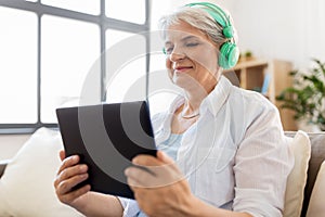 Senior woman in headphones listening to music