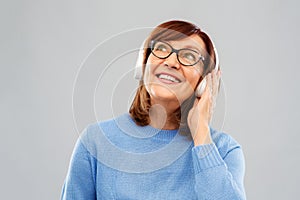 Senior woman in headphones listening to music