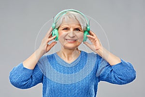 Senior woman in headphones listening to music