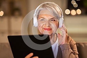 Senior woman in headphones listening to music