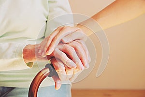 Senior woman with her caregiver at home. Concept senior people health care.