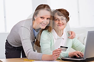 Senior woman with her daughter online purchasing