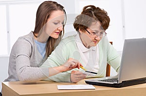Senior woman with her daughter online purchasing