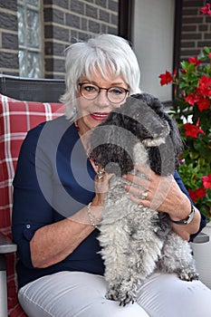 Senior woman and her dog  in the garden