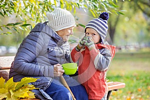 Senior woman and her great grandson drinking hot tea