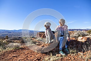 Senior woman on a hike with her dog out in nature