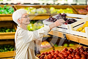 Senior woman holding bag with apple