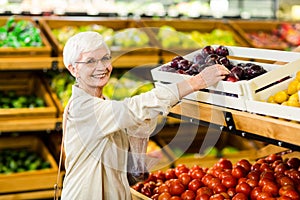 Senior woman holding bag with apple