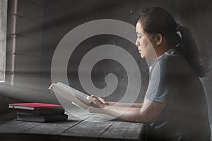 Senior woman holding a bible in her hands and reading