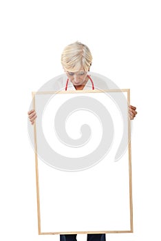Senior woman holding blank poster