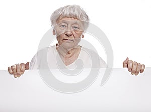 Senior woman holding a blank sign