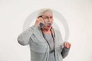 Senior woman holding cell phone.