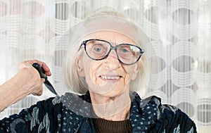 Senior woman holding a comb