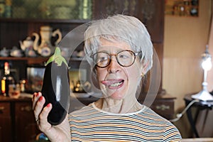 Senior woman holding a delicious eggplant