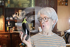 Senior woman holding a delicious eggplant