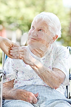 Senior Woman Holding Hands with Caretaker photo