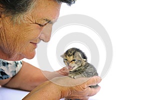 Senior woman holding kitten