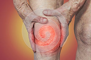 Senior woman holding the knee with pain