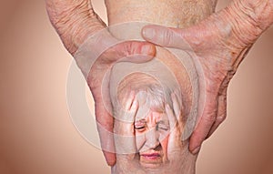 Senior woman holding the knee with pain.