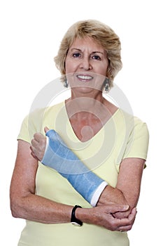 Senior woman holding left arm in cast