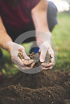 Senior woman holding soil in her hands