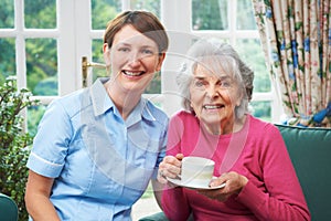 Senior Woman At Home With Carer