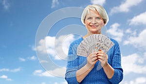 Senior woman with hundred dollar money banknotes