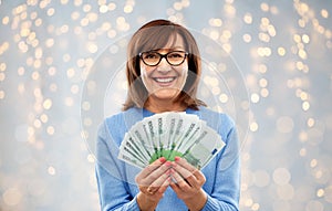 Senior woman with hundreds of euro money banknotes