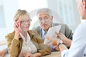 Senior woman with husband in optical store