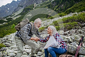 Senior woman injured her arm during hike in the mountains.