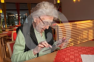 Senior woman looking at screen of tablet computer