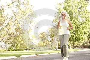 Senior Woman Jogging In Park