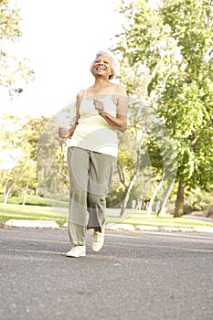 Senior Woman Jogging In Park