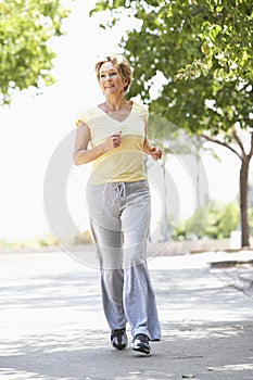 Senior Woman Jogging In Park