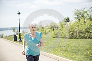 Senior Woman Jogging In Park