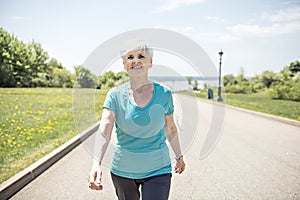 Senior Woman Jogging In Park