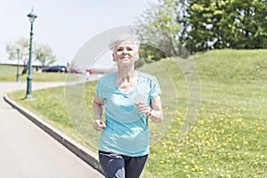 Senior Woman Jogging In Park