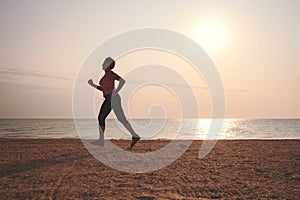 Senior woman jogging on sea beach