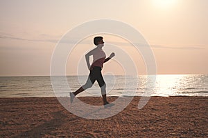 Senior woman jogging on sea beach