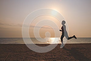 Senior woman jogging on sea beach