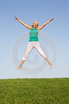 Senior woman jumping in air