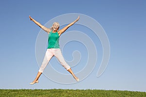 Senior woman jumping in air